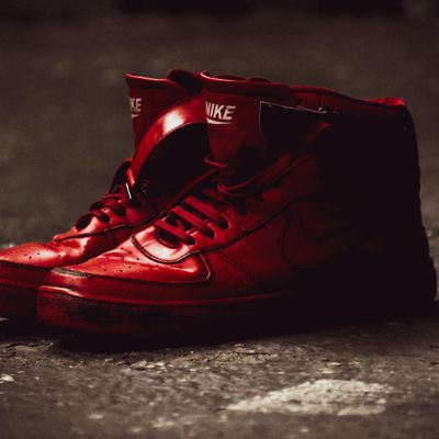 A pair of comfortable sneakers on a dark floor.